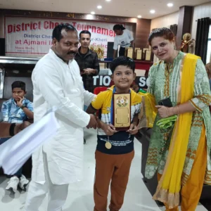 11years old student receiving winning token from organiser after winning tournamet lucknow