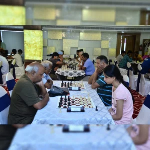 coach and student paying chess together during tournament