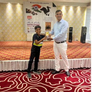 student receiving winning trophy from the organiser chess tournament lucknow